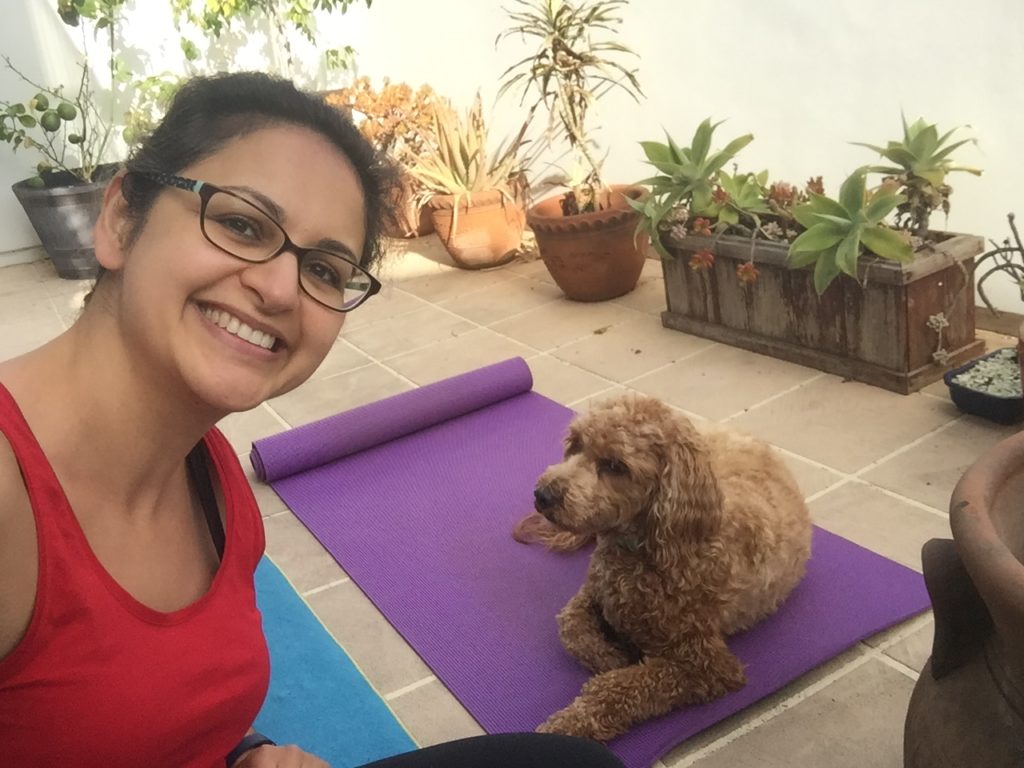 Pantea Rahimian practicing yoga from home with her dog Rylee