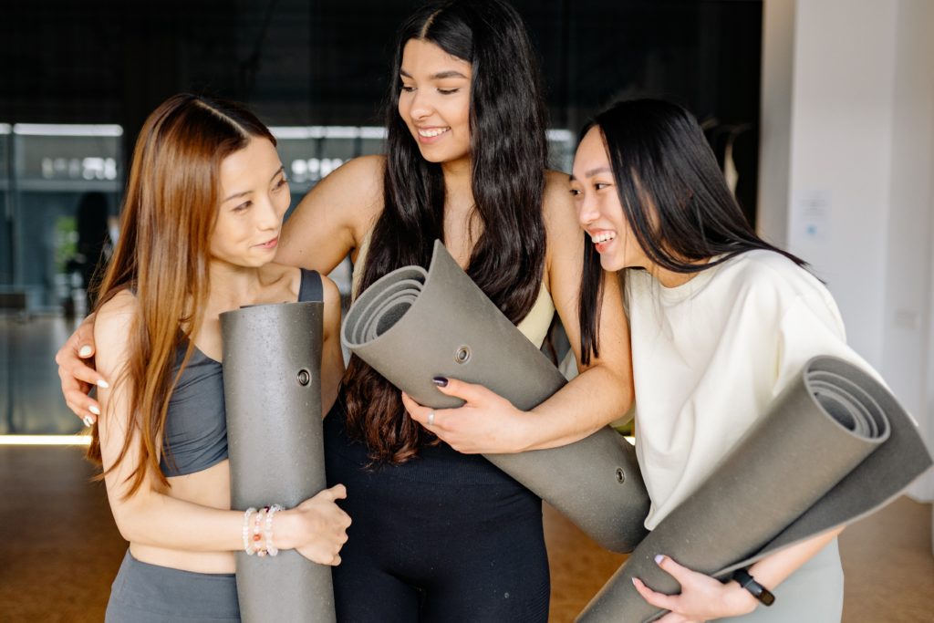 How to be happy: a group of three women doing yoga together