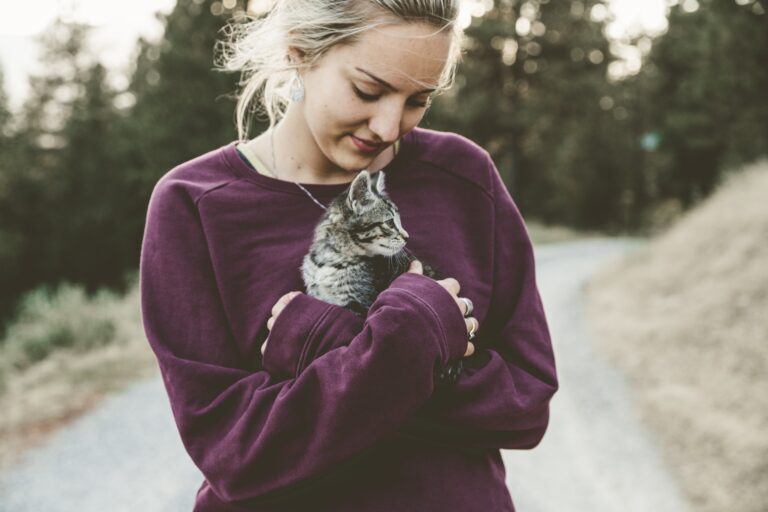 free self-care ideas for adults a woman holding a kitten