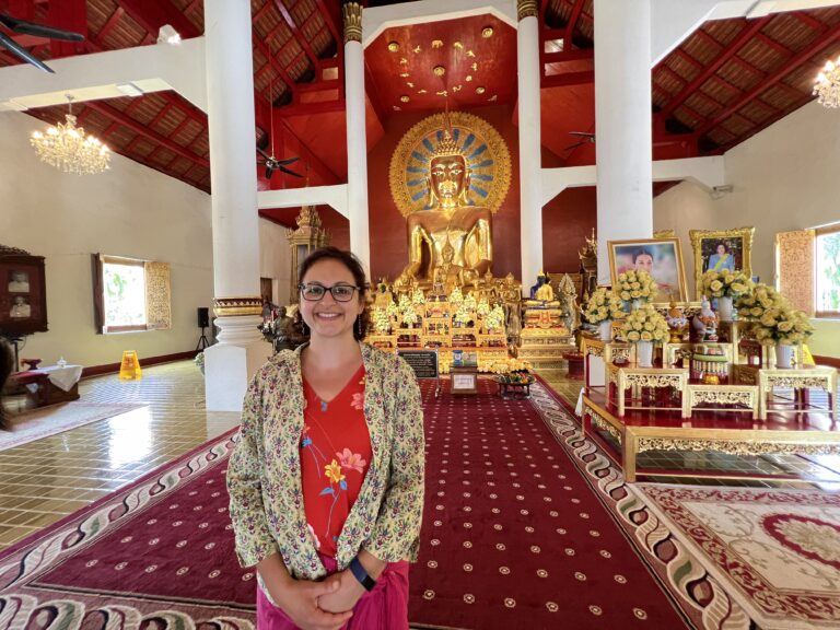 Pantea Rahimian in front of Buddha statue